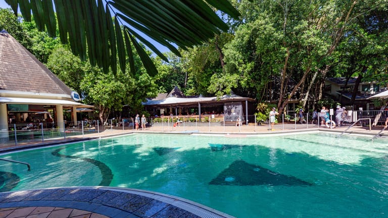 View of the Green Island Day pool with a pool bar and restaurant in the background.